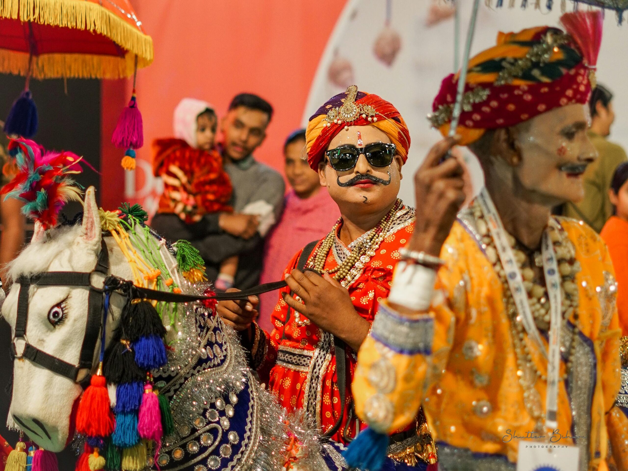 Colorful performers in traditional attire at a cultural parade in New Delhi, India.